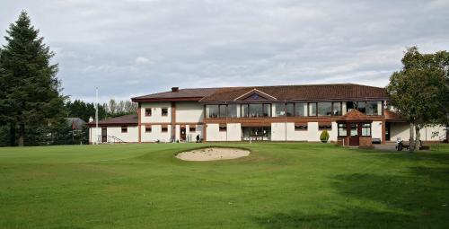 a large building with a putting green in front of it at Taigh d'Luxe in Inverness