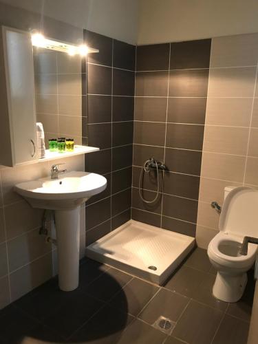 a bathroom with a sink and a toilet at Il Mondo Apartments in Stavros