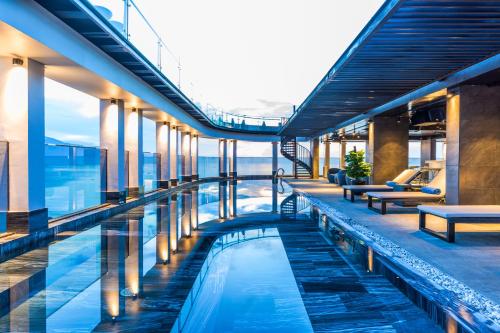 an infinity pool on the top of a building at Stella Maris Beach Danang in Da Nang