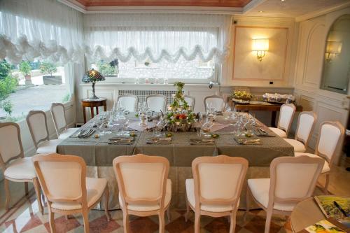 a large dining room with a long table and chairs at Hotel Villa Florida & Suite Apartments in Gardone Riviera