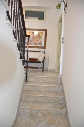 a staircase in a house with white walls at Donna Alda Affittacamere Capitello dal 2012 in Villammare
