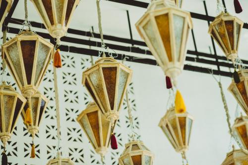 a bunch of lights hanging from a ceiling at Lanna Oriental Hotel in Chiang Mai