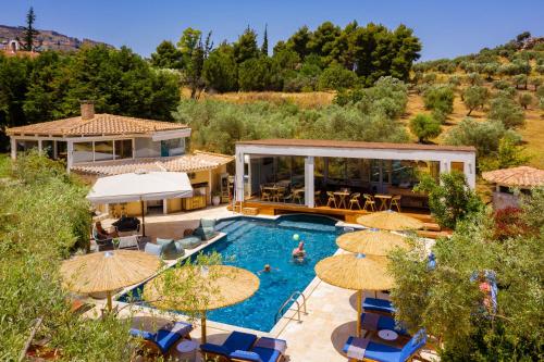 a villa with a swimming pool with umbrellas at Anthemion Suites and Villas in Nafplio
