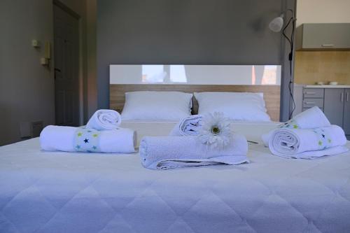 a large white bed with towels and towels at Ring Inn Apartments in Obrenovac