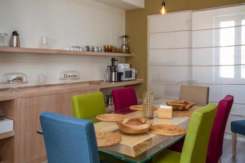 a dining room with a table and colorful chairs at Don Franco in Adelfia