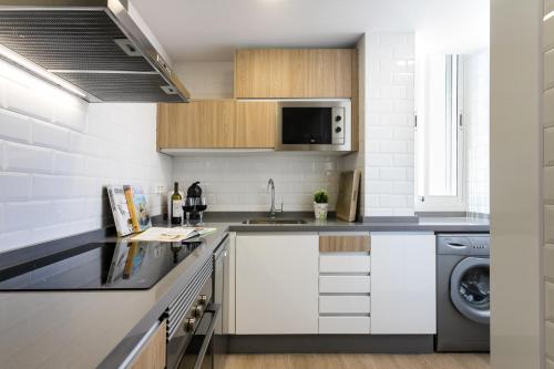 a kitchen with a sink and a dishwasher at Atico en playa muchavista san juan Estrella in El Campello