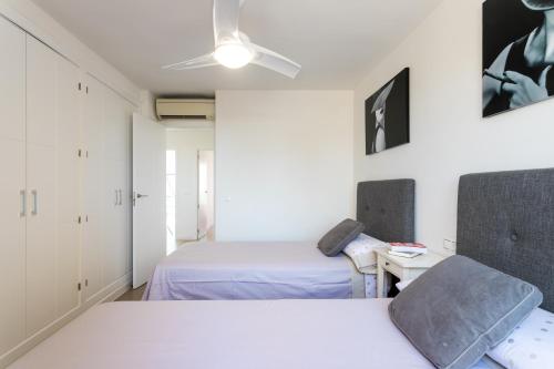 a bedroom with two beds and a table with a chair at Atico en playa muchavista san juan Estrella in El Campello