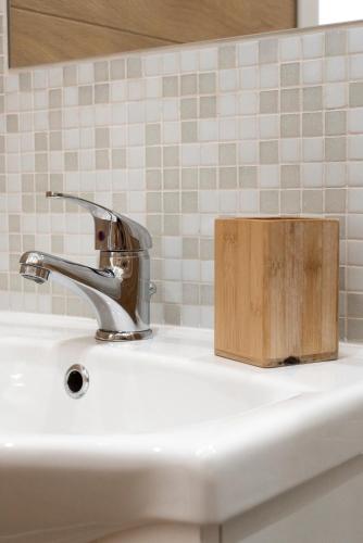 a sink with a faucet and a wooden box on it at St. Paul Palace Relais in Rome