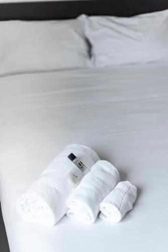 a white bed with two rolled up towels on it at St. Paul Palace Relais in Rome