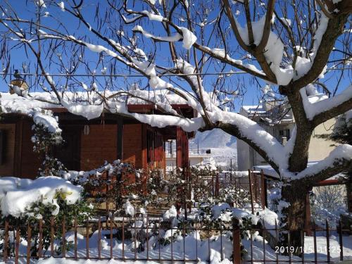 a fence covered in snow next to a building at WOODEN HOUSE IN IOANNINA in Ioannina