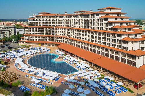 an aerial view of a hotel with a pool and umbrellas at Melia Sunny Beach All Inclusive in Sunny Beach