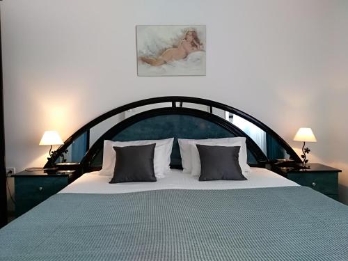 a bedroom with a large bed with a large headboard at Apartments & Rooms Vitt in Vis