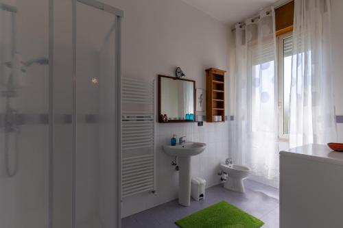 a white bathroom with a sink and a shower at B&B Luci a'mmare in Roseto degli Abruzzi