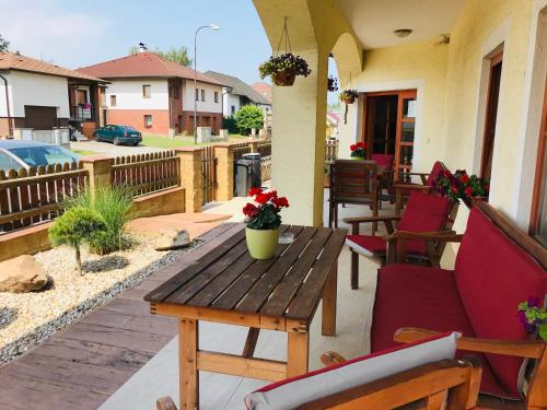 a patio with a wooden table and chairs at Penzion Bělidlo in Kunžak