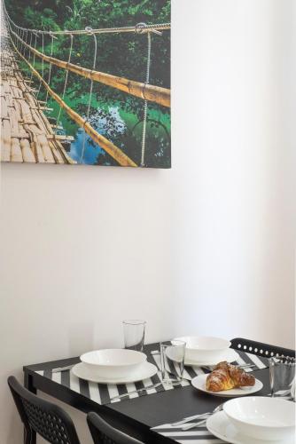 a black table with plates of food and a boat at St. Paul Palace Relais in Rome