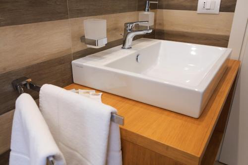 a bathroom with a sink and towels on a counter at Vignadonica Resort in Fisciano