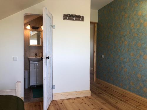 an open door in a room with a sink at ALANTOS ŽIRGAI Holiday Villas sauna or hottube additional price in Alanta