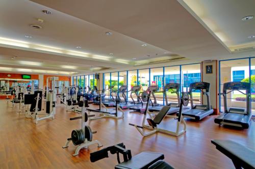 a gym with a lot of treadmills and exercise bikes at The Pacific Sutera Hotel in Kota Kinabalu