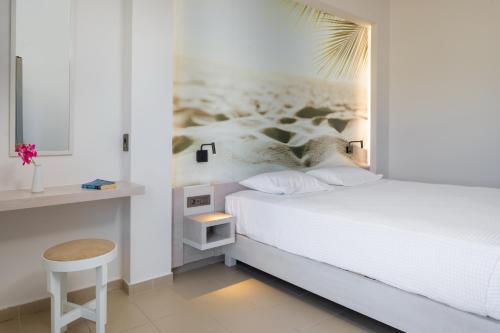 a white bedroom with a bed and a desk at Forum City Apartments in Chania