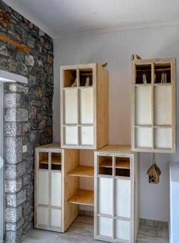 a room with wooden shelves and a brick wall at Pefkos Eye in Pefki Rhodes