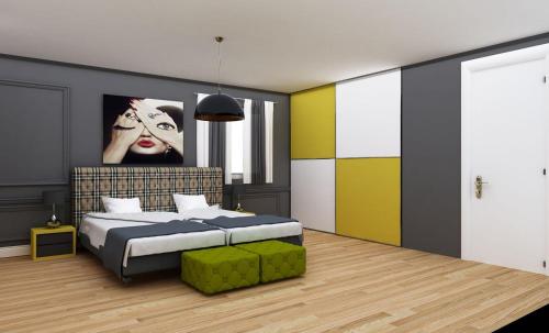 a bedroom with a bed and a painting of a woman at London Apartments in Rheineck