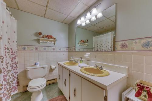 a bathroom with a toilet and a sink and a mirror at Bunker Lane Golf Course in Bartlett