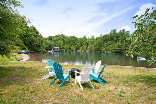 a group of chairs sitting around a table by a lake at Pebble Beach in Bumpass