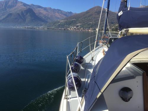 a boat in the water with mountains in the background at Casa Ninou in Domaso