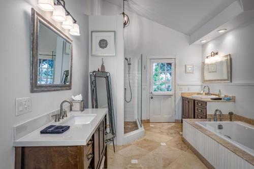 a bathroom with two sinks and a tub and a shower at Spectacular View in Sedona
