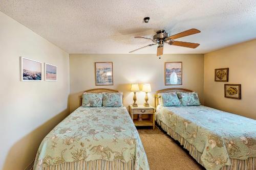 a bedroom with two beds and a ceiling fan at Solare Garden Villa #773 in South Padre Island
