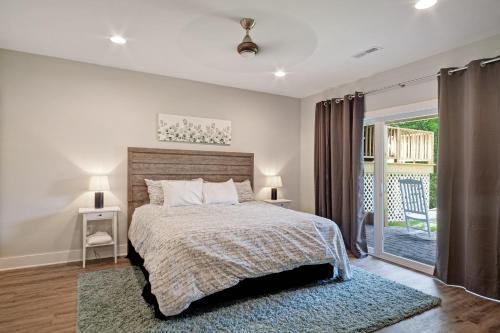 a bedroom with a bed and a sliding glass door at Pebble Beach in Bumpass