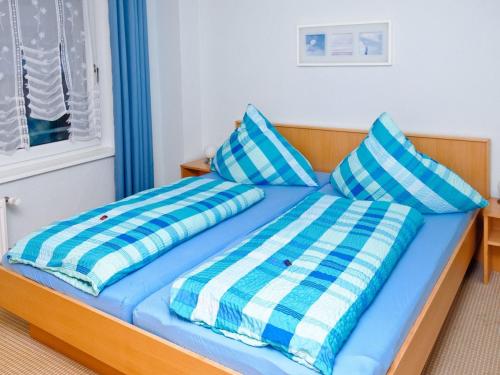 ヴィスマールにあるPeaceful Apartment in Wismar Germany near Beachのベッド(青と白の枕付)