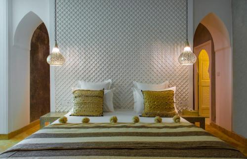 a bedroom with a large bed with two pillows at Riad Jawad & Spa in Marrakech