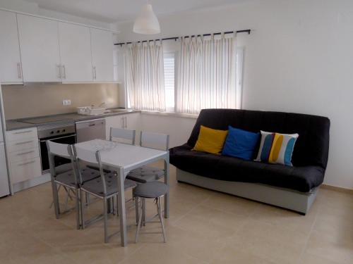 a living room with a couch and a table at Casa Amarela by Umbral in Pêra