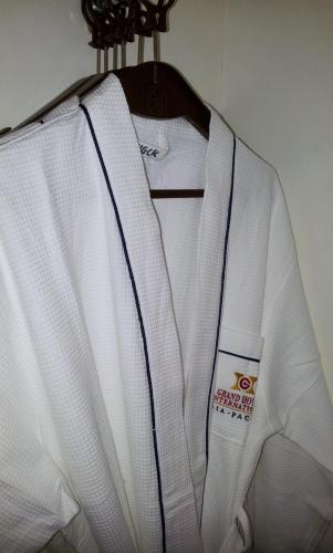 a white shirt is hanging on a rack at Hotel Grand Continental Kuantan in Kuantan