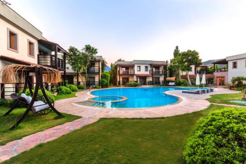 an image of a swimming pool with a playground at Faros Bodrum Hotel - Special Category in Golturkbuku