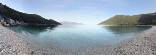 a large body of water with a rocky shore at Rosegarden in Sami