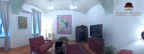 a living room with a couch and a tv at Zagreb Speeka in Zagreb