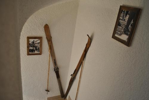 a stairway with two ski poles on the wall at Les Petits Mélèzes in Crans-Montana