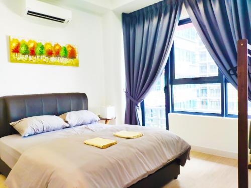 a bedroom with a bed with two towels on it at Arte Plus - Family Suite, 5 pax, Jalan Ampang in Kuala Lumpur