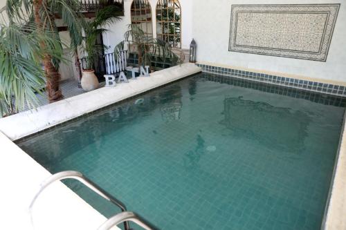 a man is standing in a swimming pool at Justin de Provence in Orange