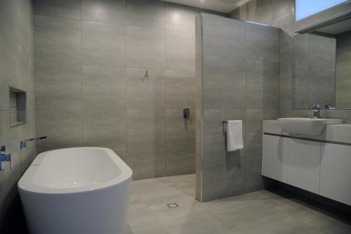 a bathroom with a toilet and a sink and a shower at Relbia Lodge in Relbia