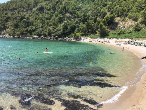 a group of people in the water at a beach at Impero 6 in Scauri