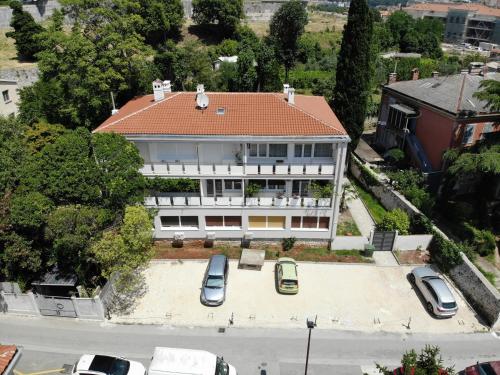 an aerial view of a building with cars parked in front at Boutique Suites Joyce in Pula