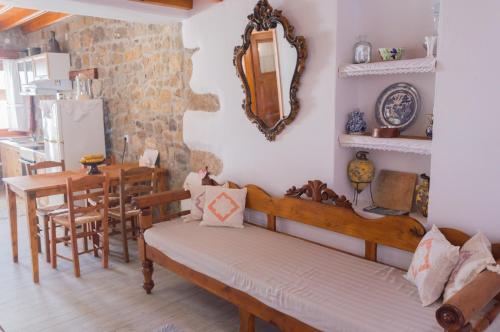 a room with a bed and a table and a kitchen at Manos House in Chora in Patmos