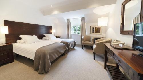a hotel room with two beds and a television at Blind Gate House in Kinsale
