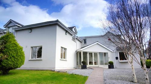 a white house with a driveway at Blind Gate House in Kinsale