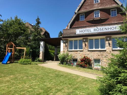 a hotel with a playground in front of a building at Hotel Rosenhof Braunlage in Braunlage