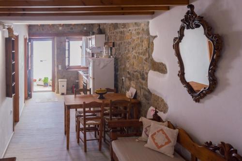 a living room with a table and a mirror on the wall at Manos House in Chora in Patmos