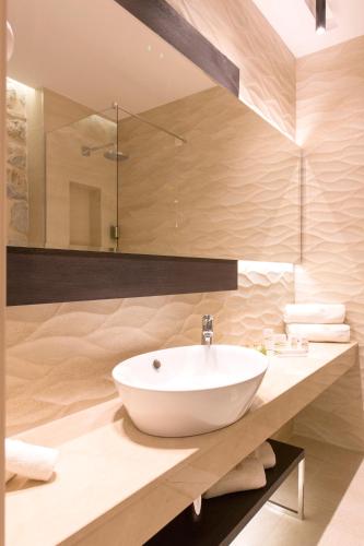 a bathroom with a white sink and a shower at Heritage Hotel Leon Coronato in Perast
